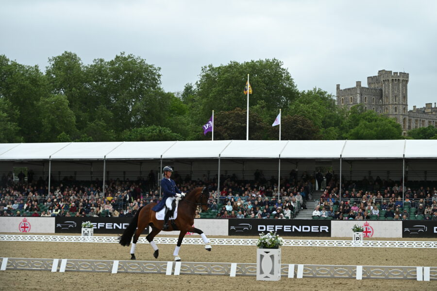 man riding dressage in arena in front on windsor castle