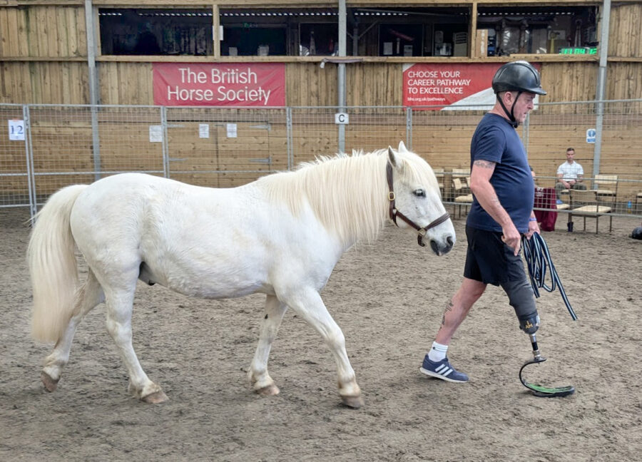 man walking in front of horse